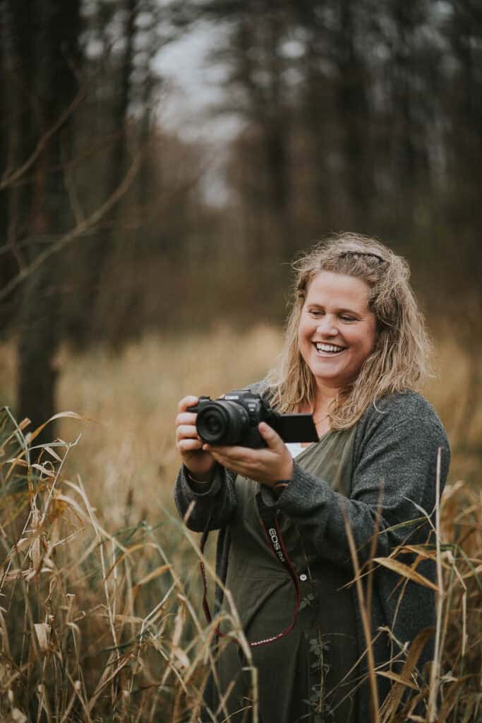 Zoey Elinor smilende med kamera. Blød og jordnær stemning. Billeder til hjemmeside i Jylland.